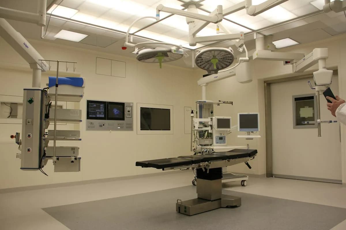 Board-certified diagnostic radiologist reviewing cross-sectional medical scans at a high-resolution PACS workstation